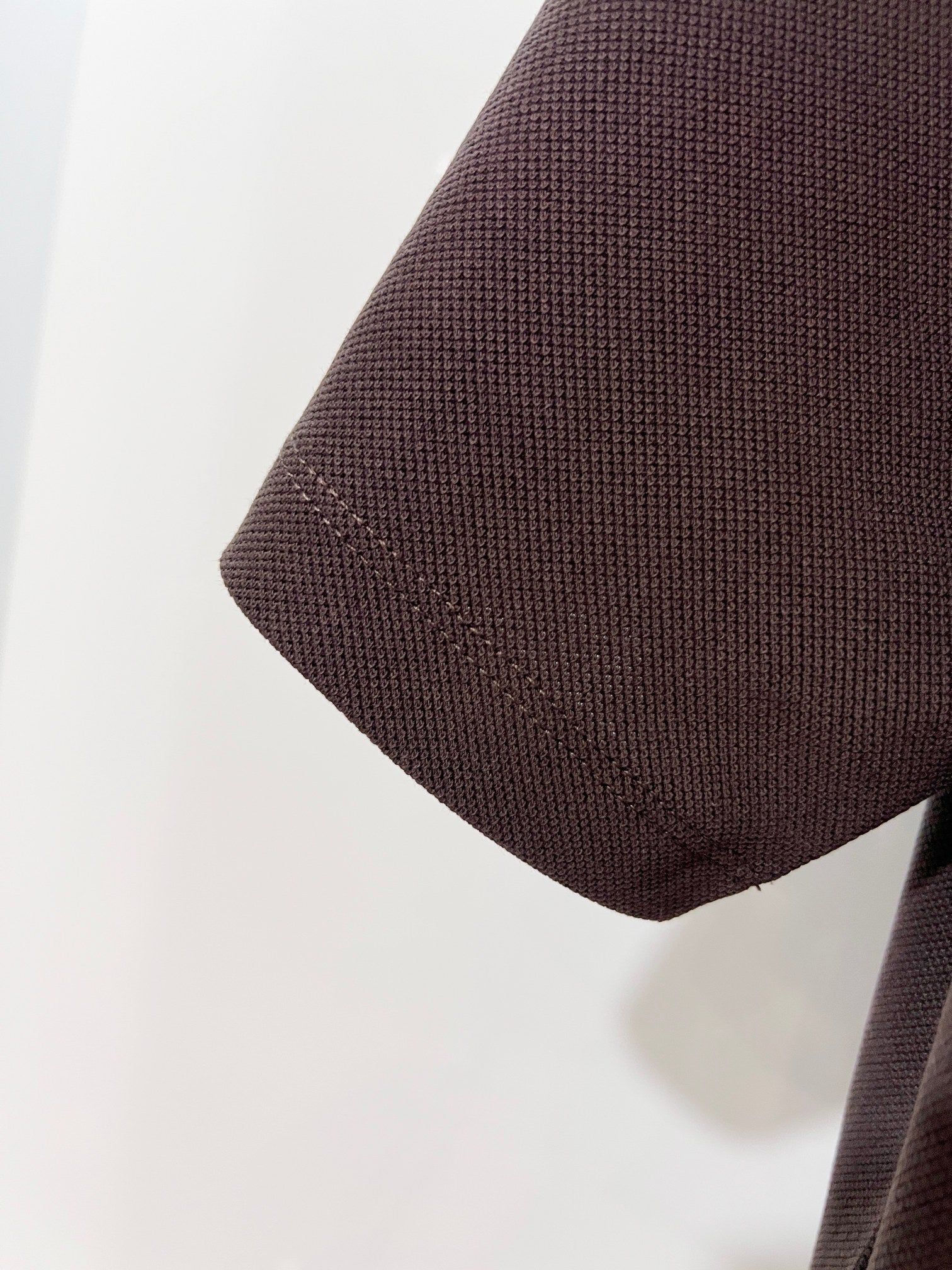 Burberry polo shirt sleeve and hem in dark brown textured fabric