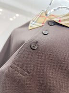 Burberry polo shirt close-up, dark brown textured knit with logo buttons