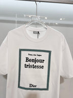 White Dior graphic T-shirt close-up with “Bonjour tristesse” front print