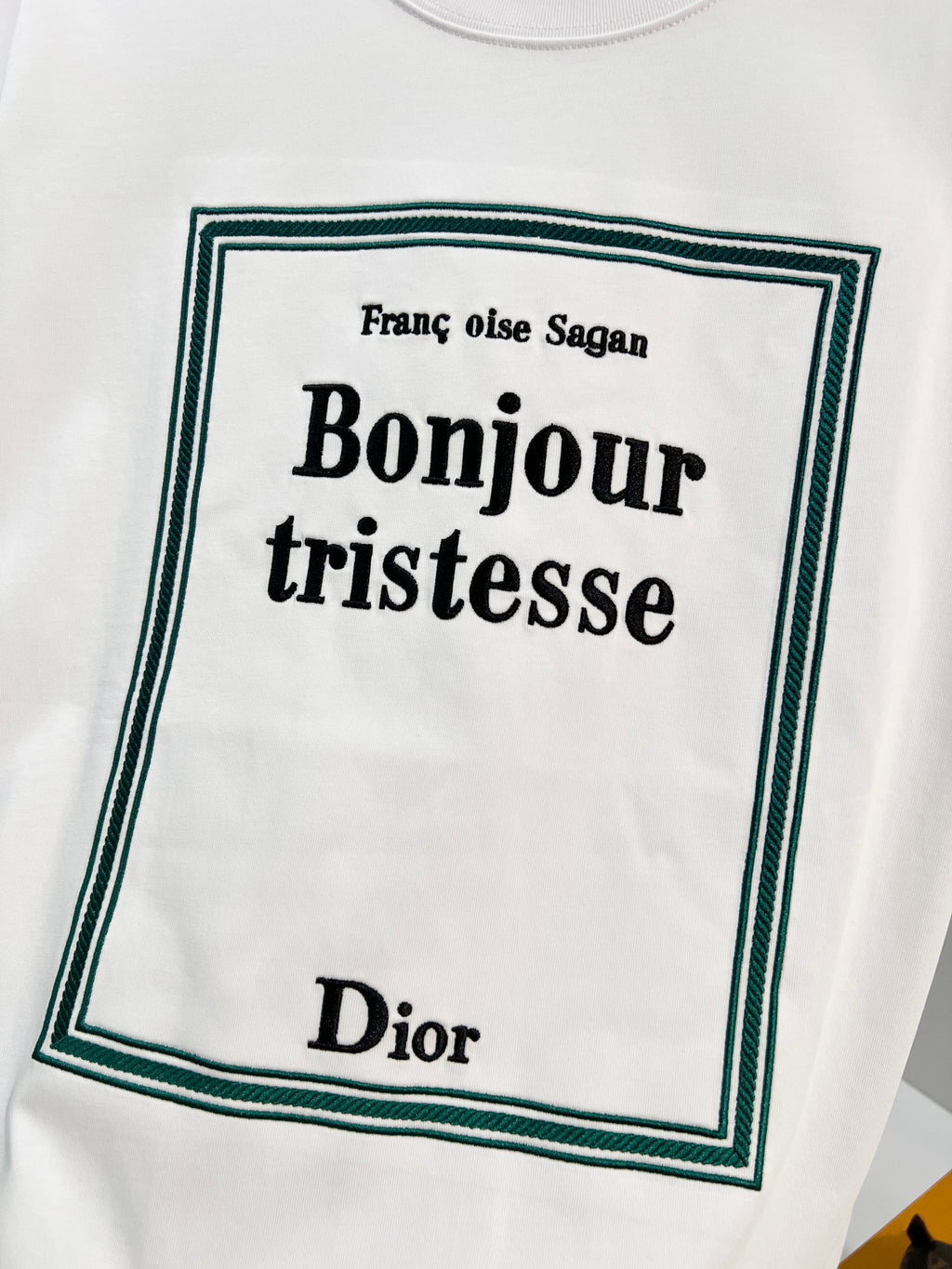 White Dior T-shirt with green-bordered “Bonjour tristesse” front graphic