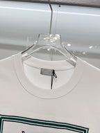 White Dior T-shirt neckline close-up on clear hanger