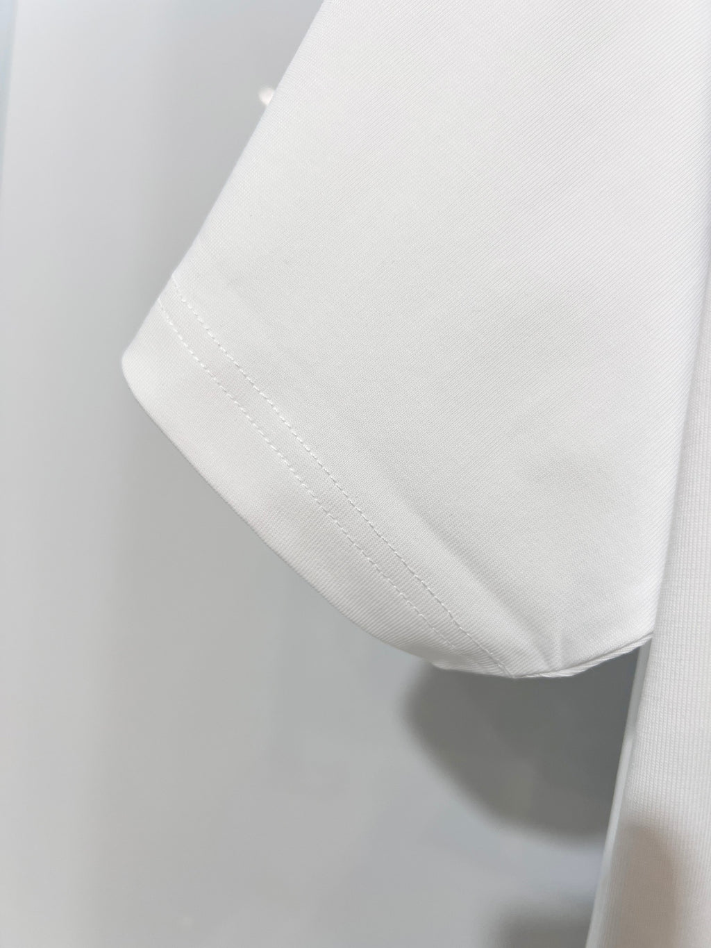 White Dior T-shirt sleeve hem with visible stitching detail