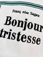 White Dior T-shirt close-up of “Bonjour tristesse” lettering on front graphic