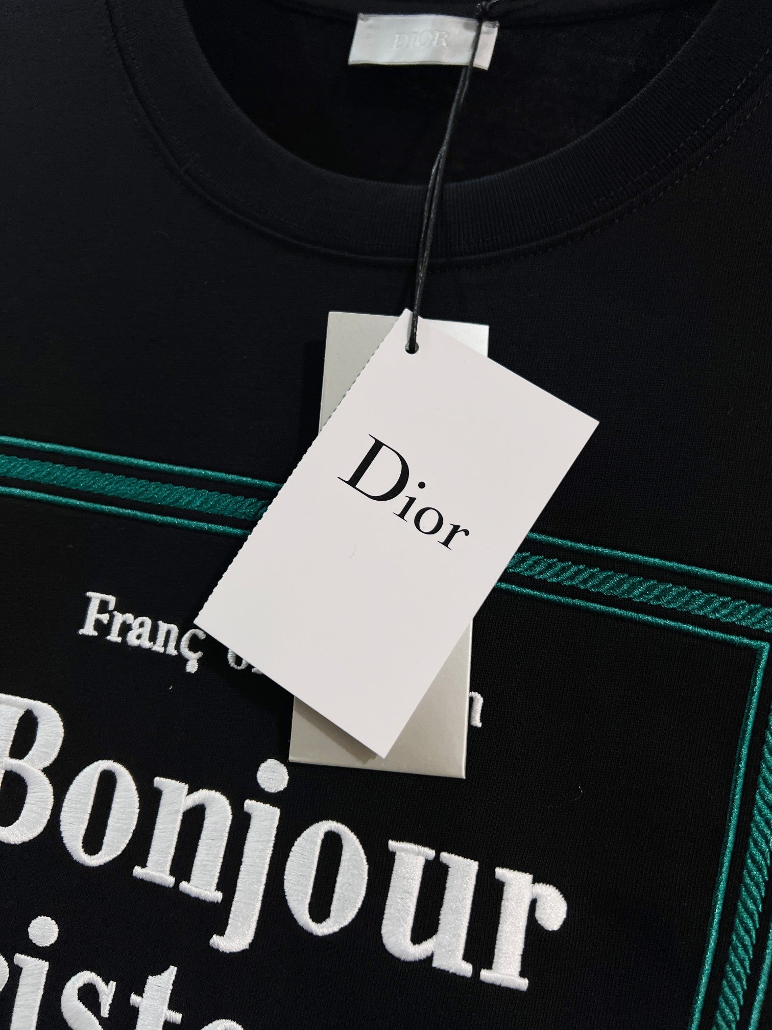 Black Dior T-shirt neckline with hanging Dior tag
