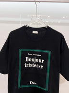 Black Dior T-shirt with 'Bonjour tristesse' logo graphic close-up