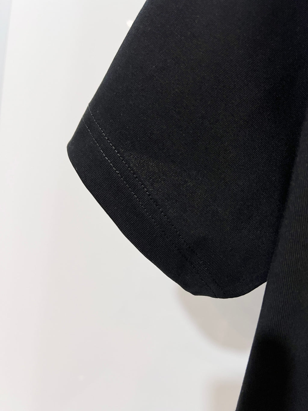 Black Dior T-shirt sleeve hem detail