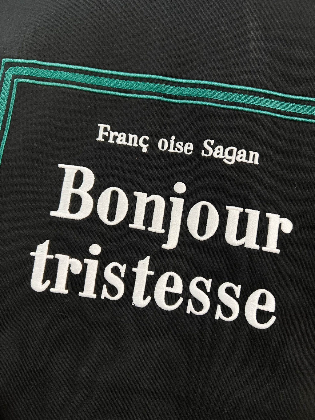 Black Dior T-shirt 'Bonjour tristesse' text graphic close-up