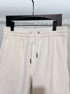 White drawstring shorts with ribbed waistband and metal eyelets