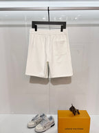 White drawstring shorts with slanted pockets and elastic waist