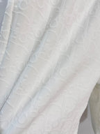 White shorts fabric with subtle allover logo-style texture