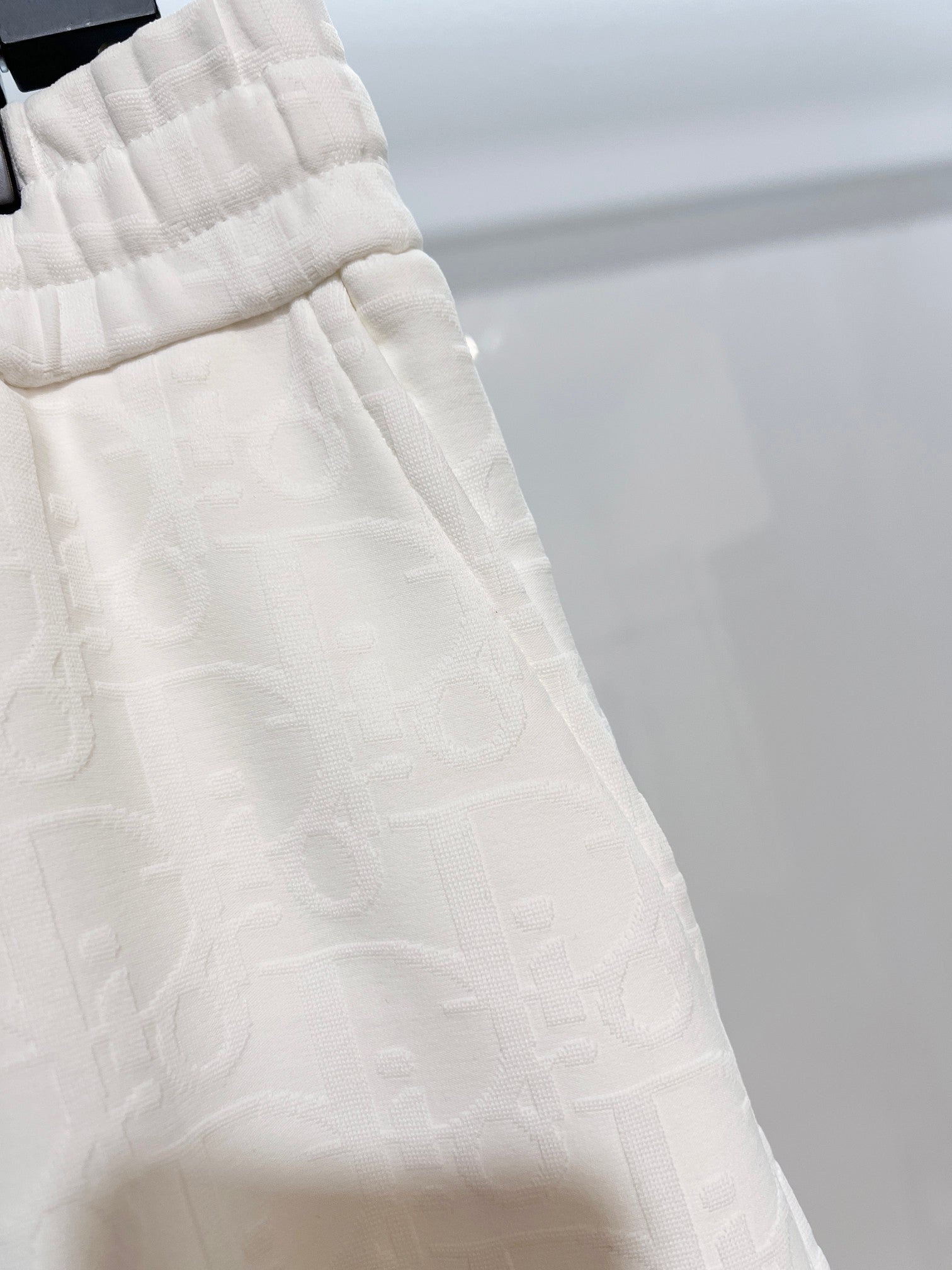 White shorts side panel with textured fabric and seam detail