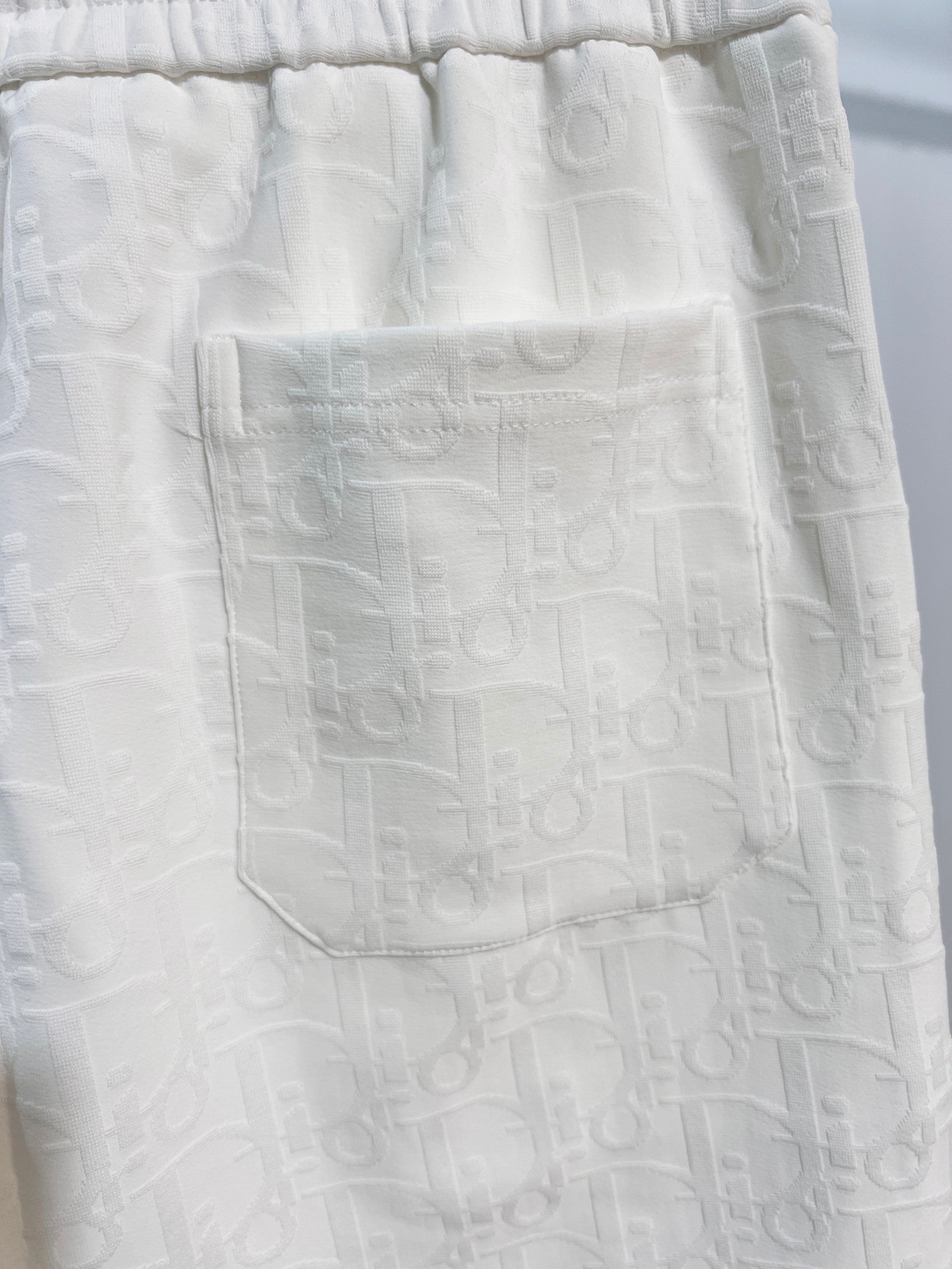 White shorts front pocket area with textured fabric pattern