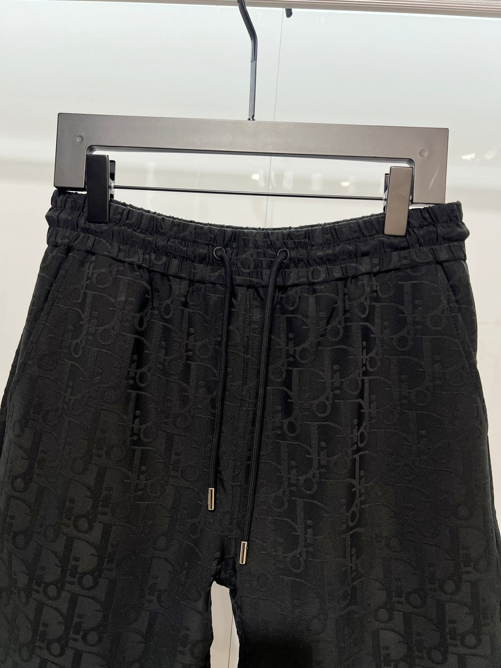 Black Dior monogram shorts, front view with elastic waist and drawstring cords