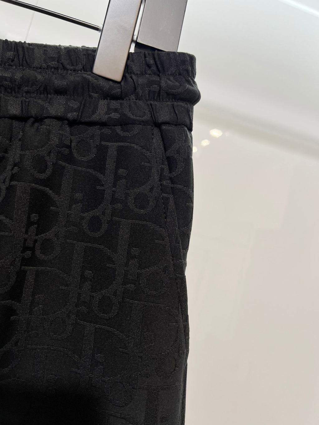 Black Dior monogram shorts on hanger with elastic waistband