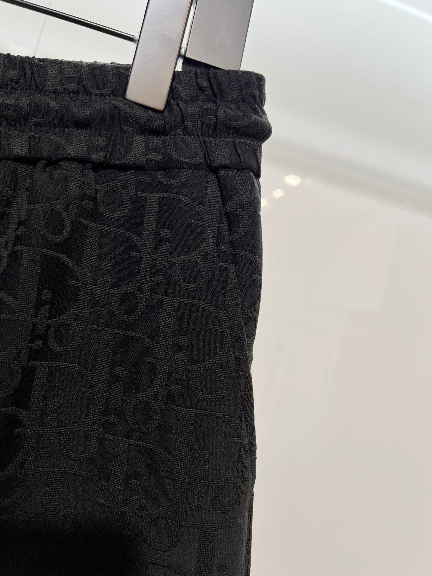 Black Dior monogram shorts on hanger with elastic waistband