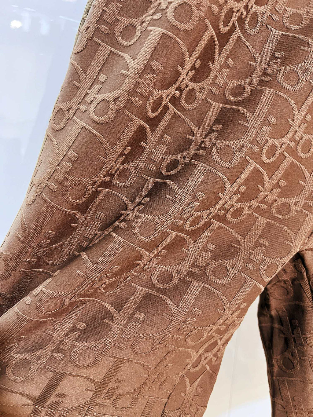 Dior logo-pattern drawstring shorts, tan-brown fabric close-up