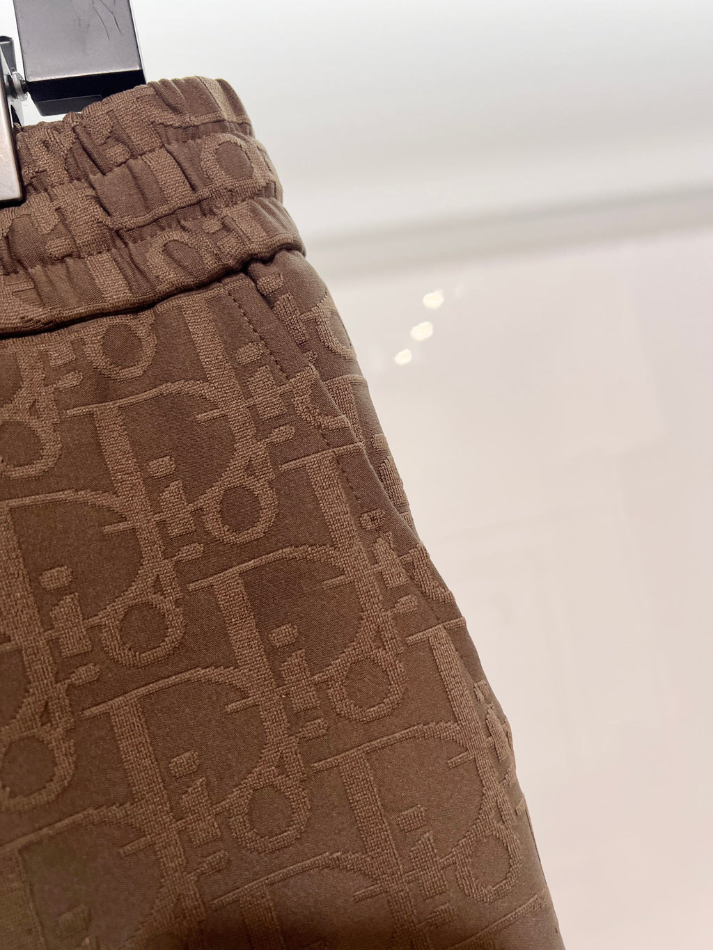 Dior logo-pattern drawstring shorts, brown side view with pleats and seams