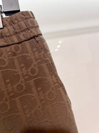Dior logo-pattern drawstring shorts, brown side view with pleats and seams