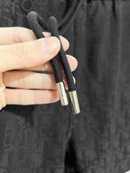 Black drawstring shorts with metal cord aglets
