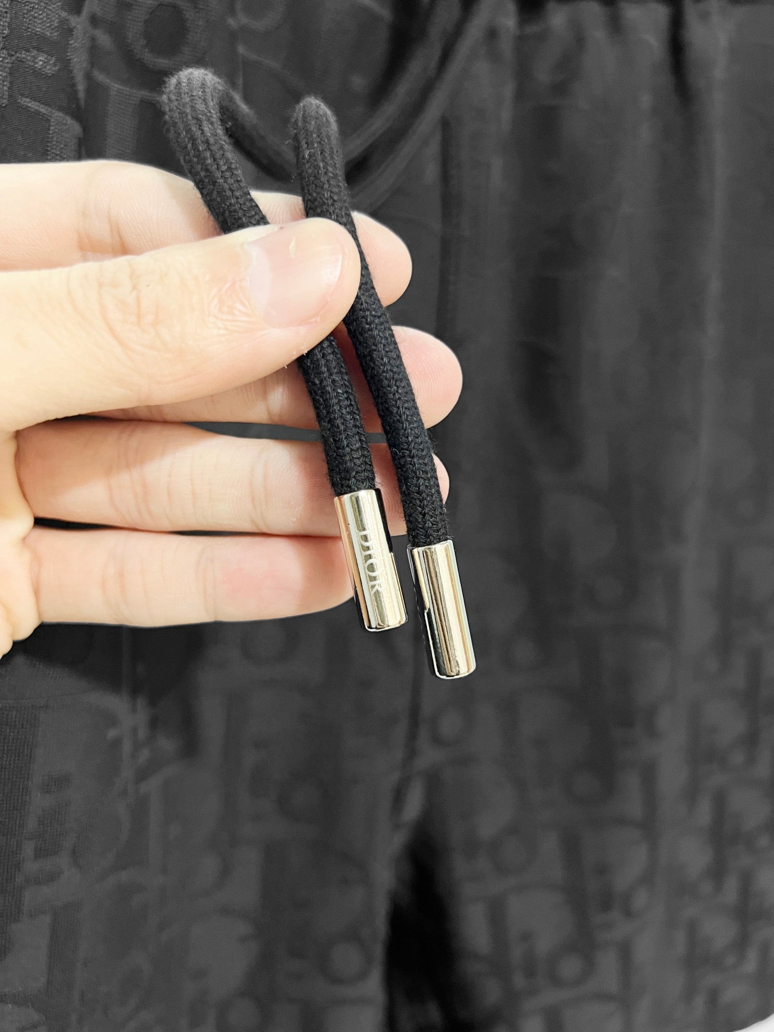 Black drawstring shorts with metal cord aglets