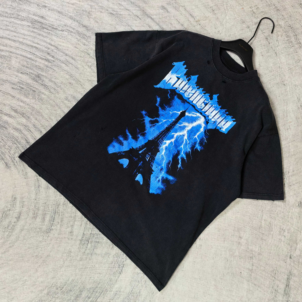 Balenciaga graphic T-shirt, dark folded; blue Eiffel lightning logo print on front