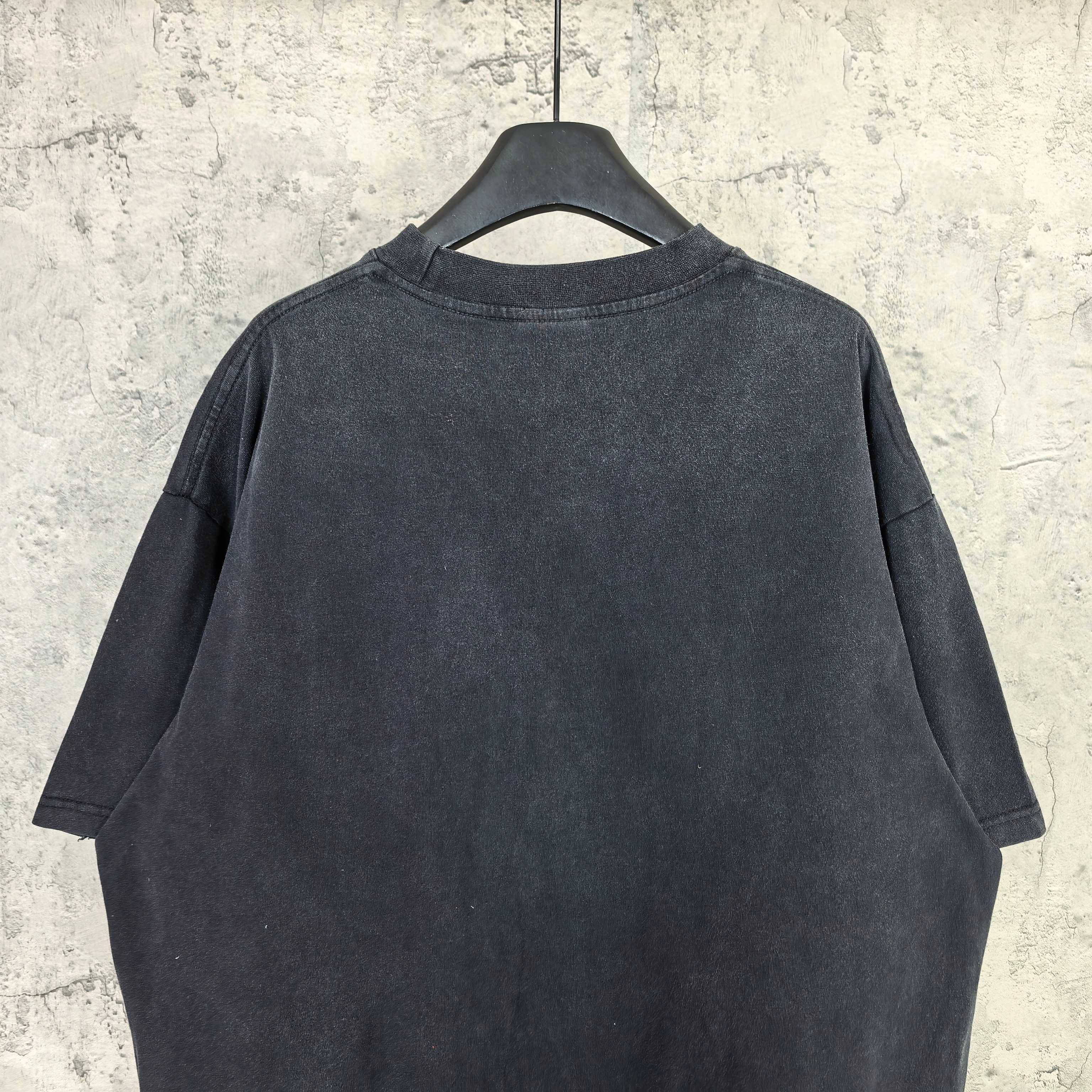 Balenciaga T-shirt, dark short-sleeve crewneck; plain back with neckline and seams visible