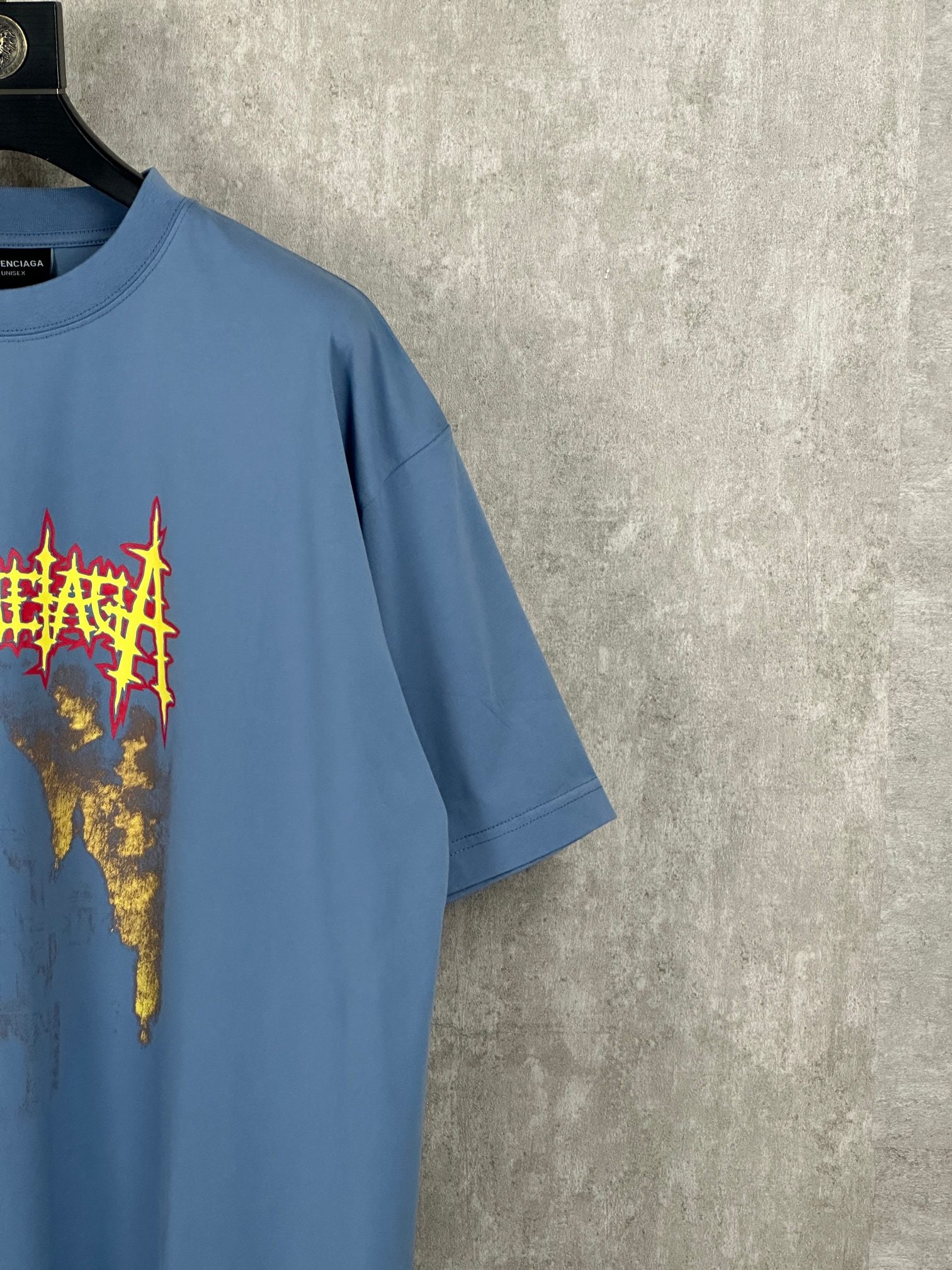Balenciaga blue T-shirt with front graphic and short sleeves, angled close-up