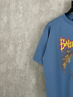 Balenciaga blue T-shirt with colorful red and gold front graphic, short sleeves, side angle