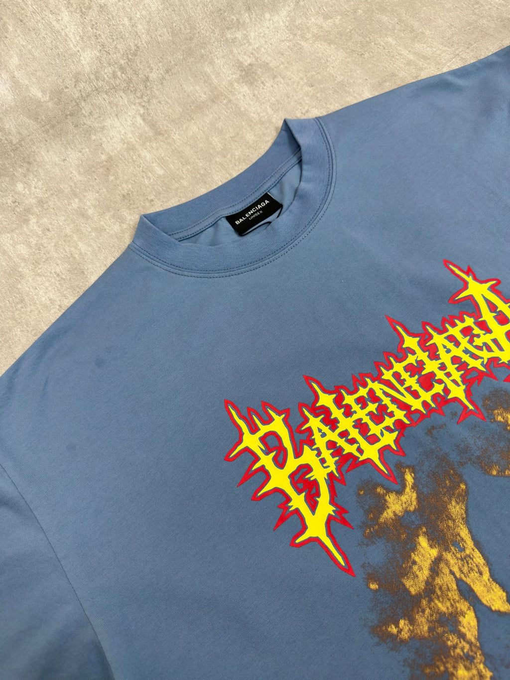 Balenciaga blue graphic T-shirt close-up, crew neck, short sleeves, red and gold print