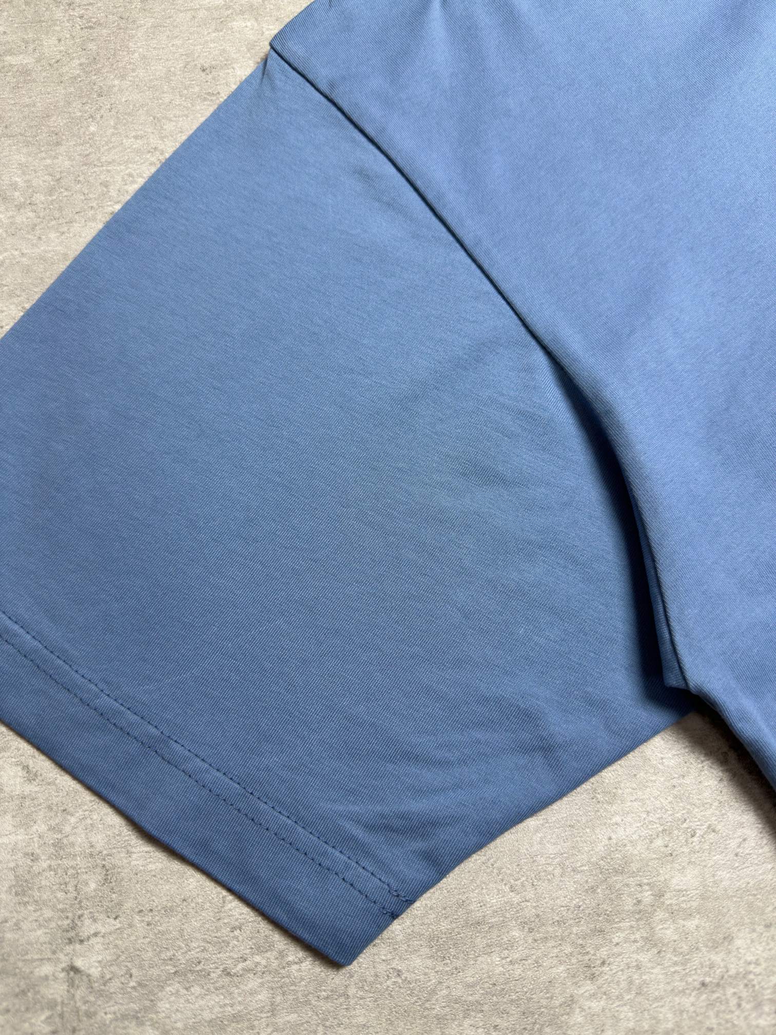 Balenciaga blue T-shirt side view close-up, short sleeves, smooth fabric fall