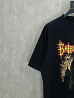 Balenciaga black short-sleeve shirt side view with partial red and yellow front graphic