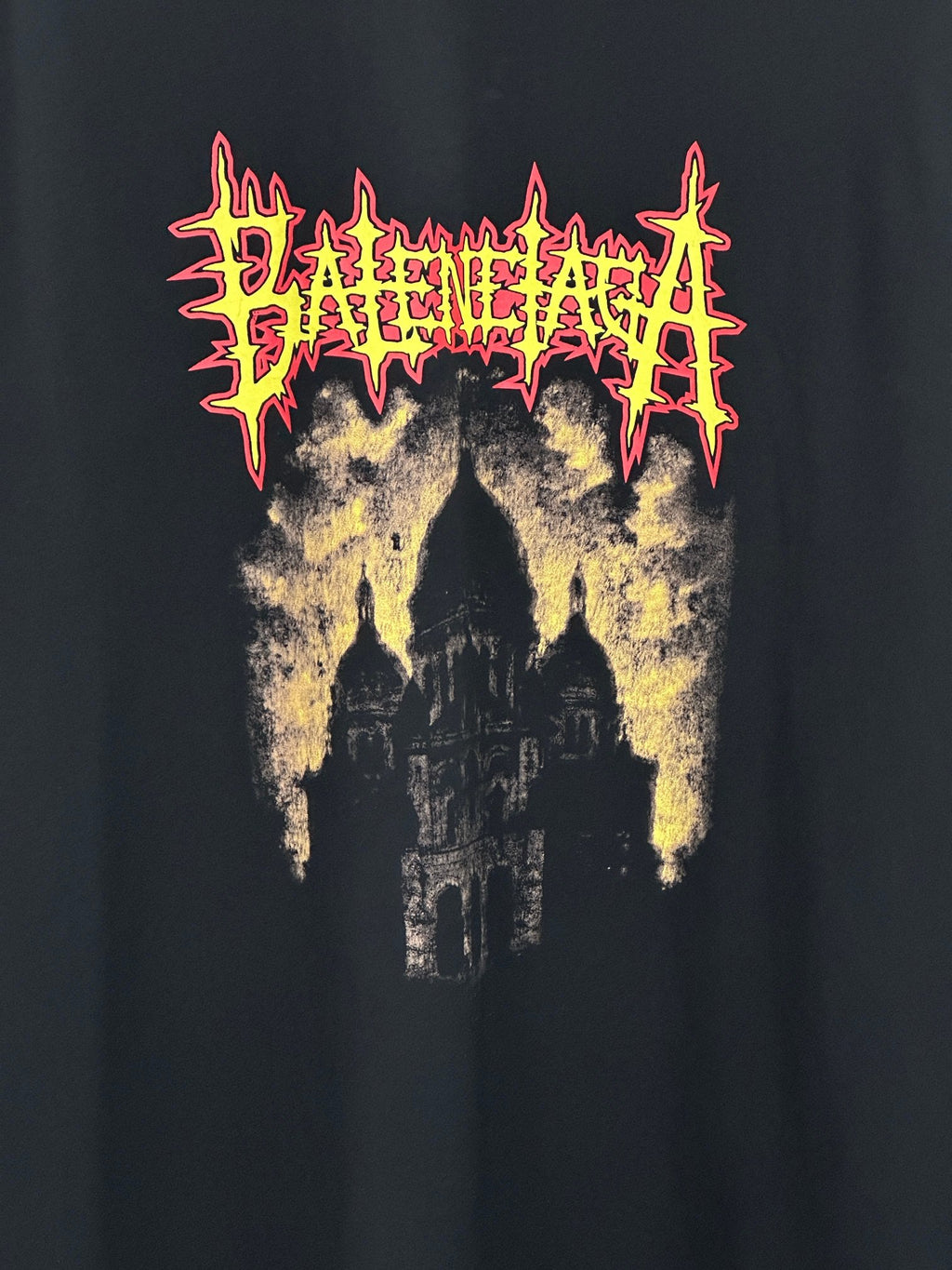 Balenciaga black short-sleeve shirt close-up, front graphic with red and yellow text