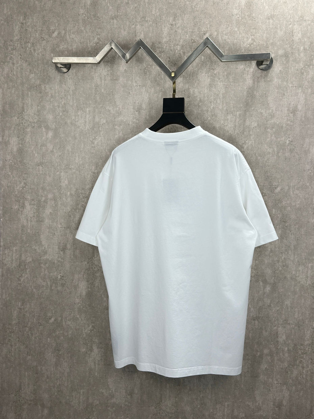 White T-shirt with crew neck, plain back, hanging on a black tag