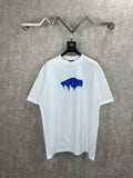 White T-shirt with blue paint graphic and crew neck on a hanger
