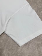 White T-shirt close-up of hem and sleeve seam, folded