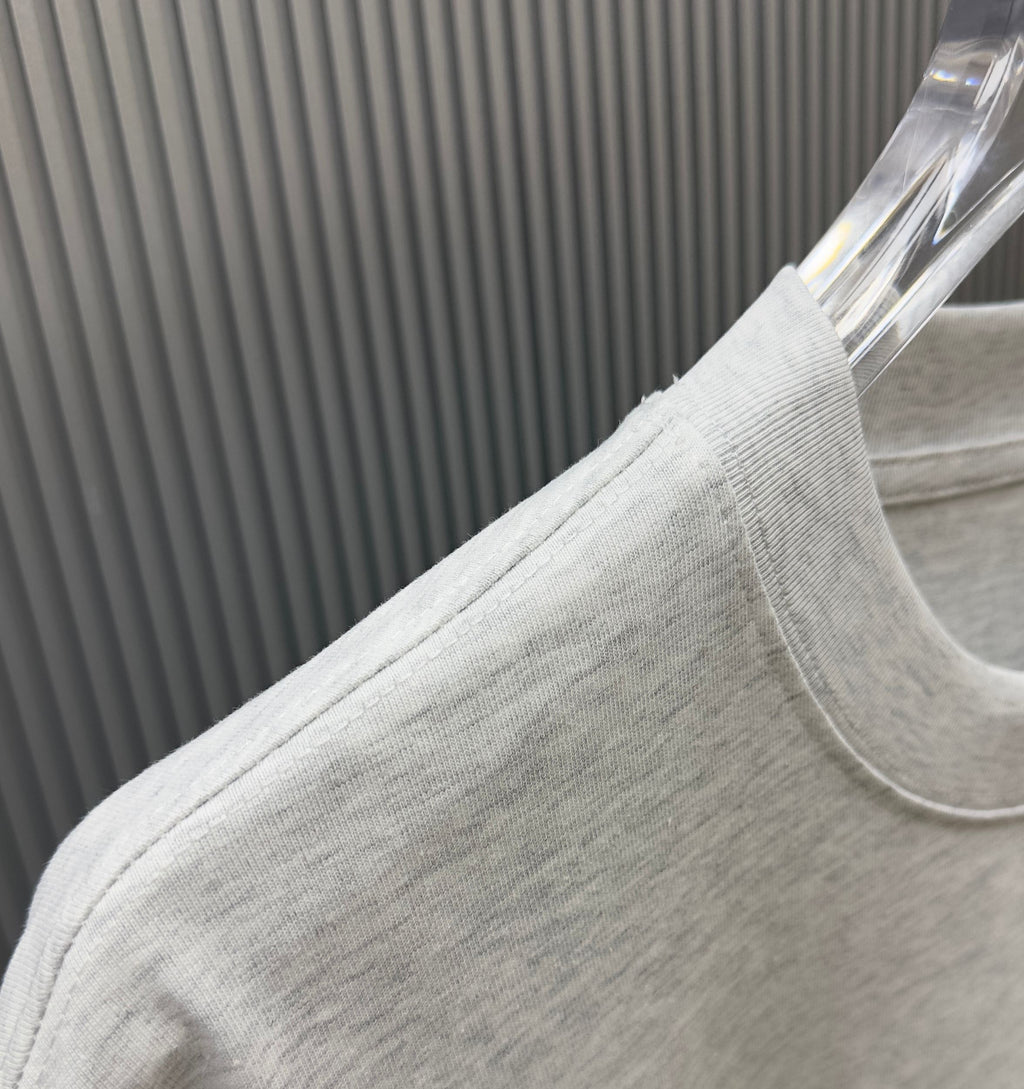 Light gray Givenchy T-shirt fabric close-up at shoulder and sleeve