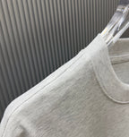 Light gray Givenchy T-shirt fabric close-up at shoulder and sleeve