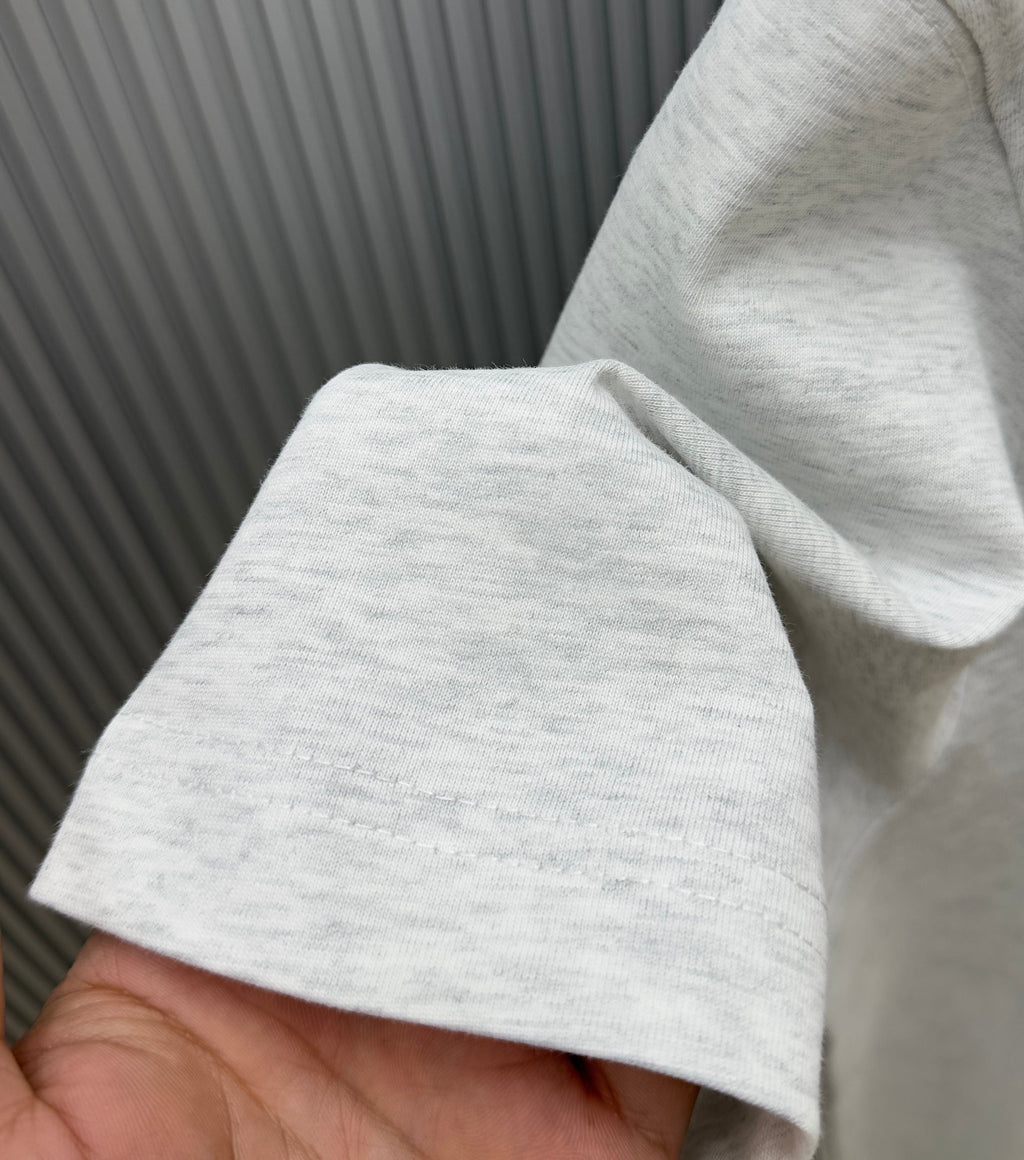 Light gray Givenchy T-shirt hem and sleeve cuff close-up