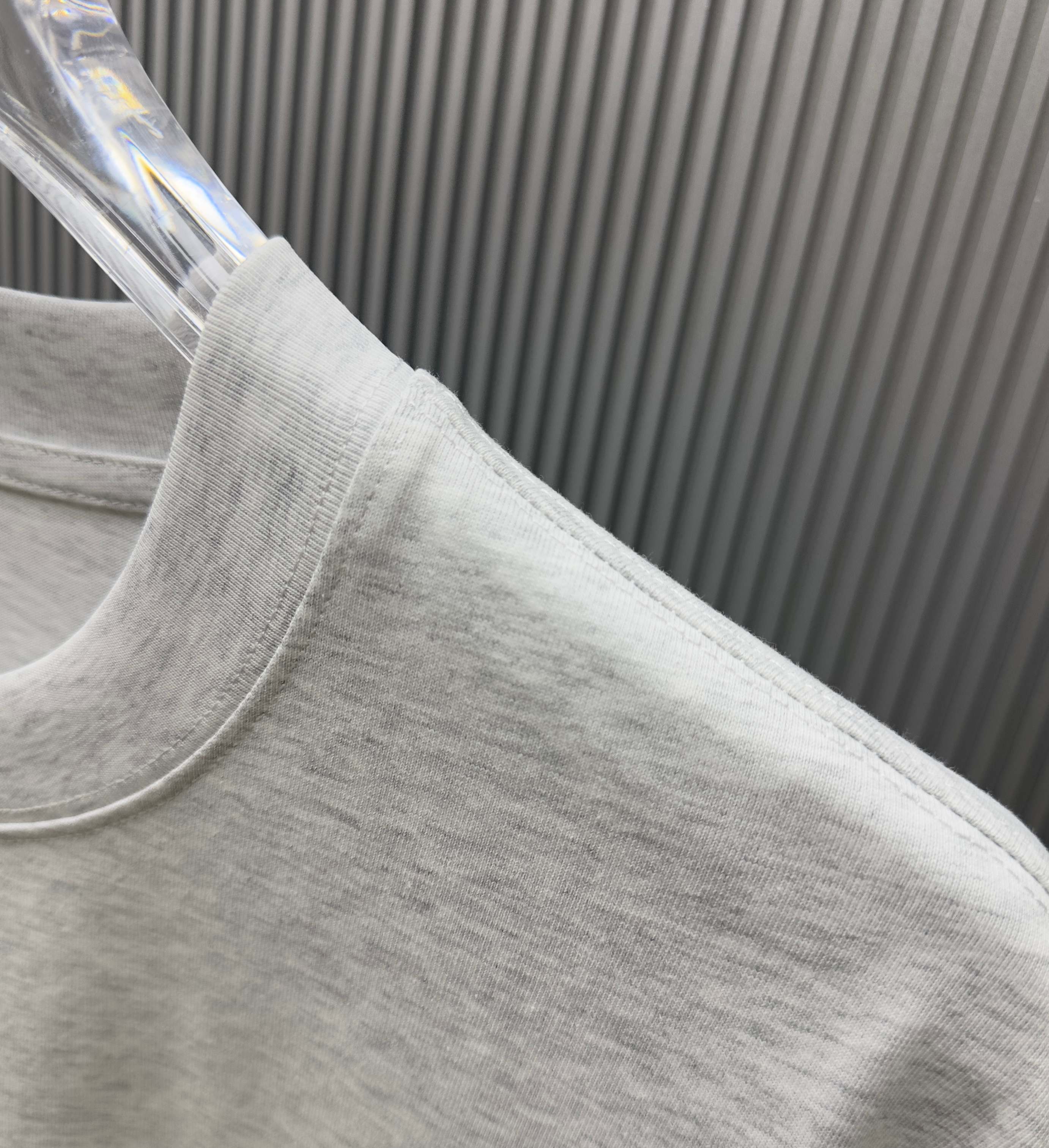 Light gray Givenchy T-shirt fabric close-up at side seam