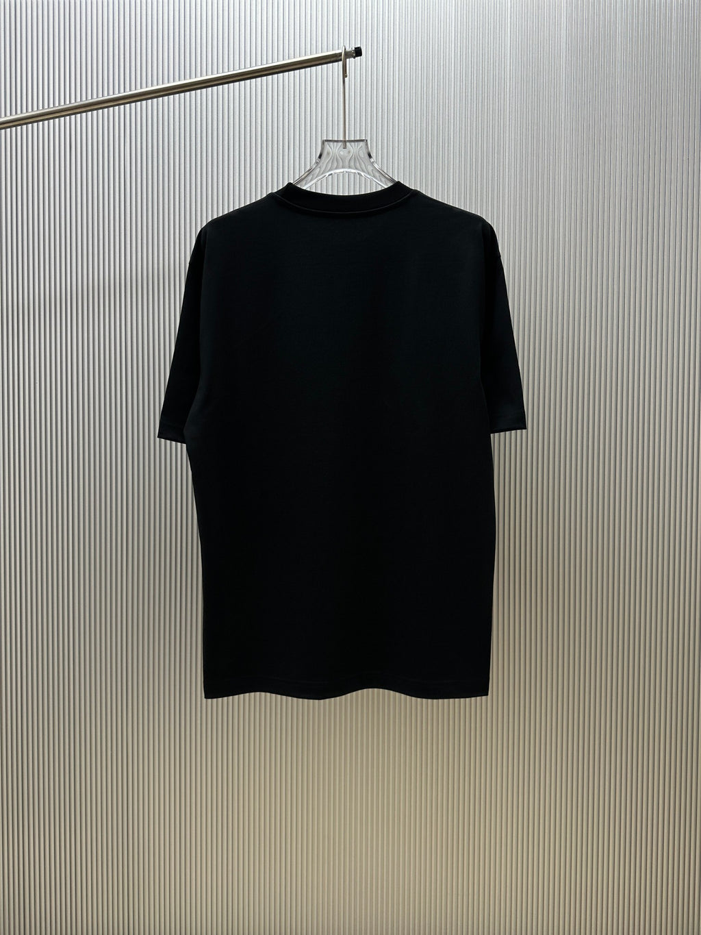 Black crew-neck short-sleeve T-shirt on a hanger