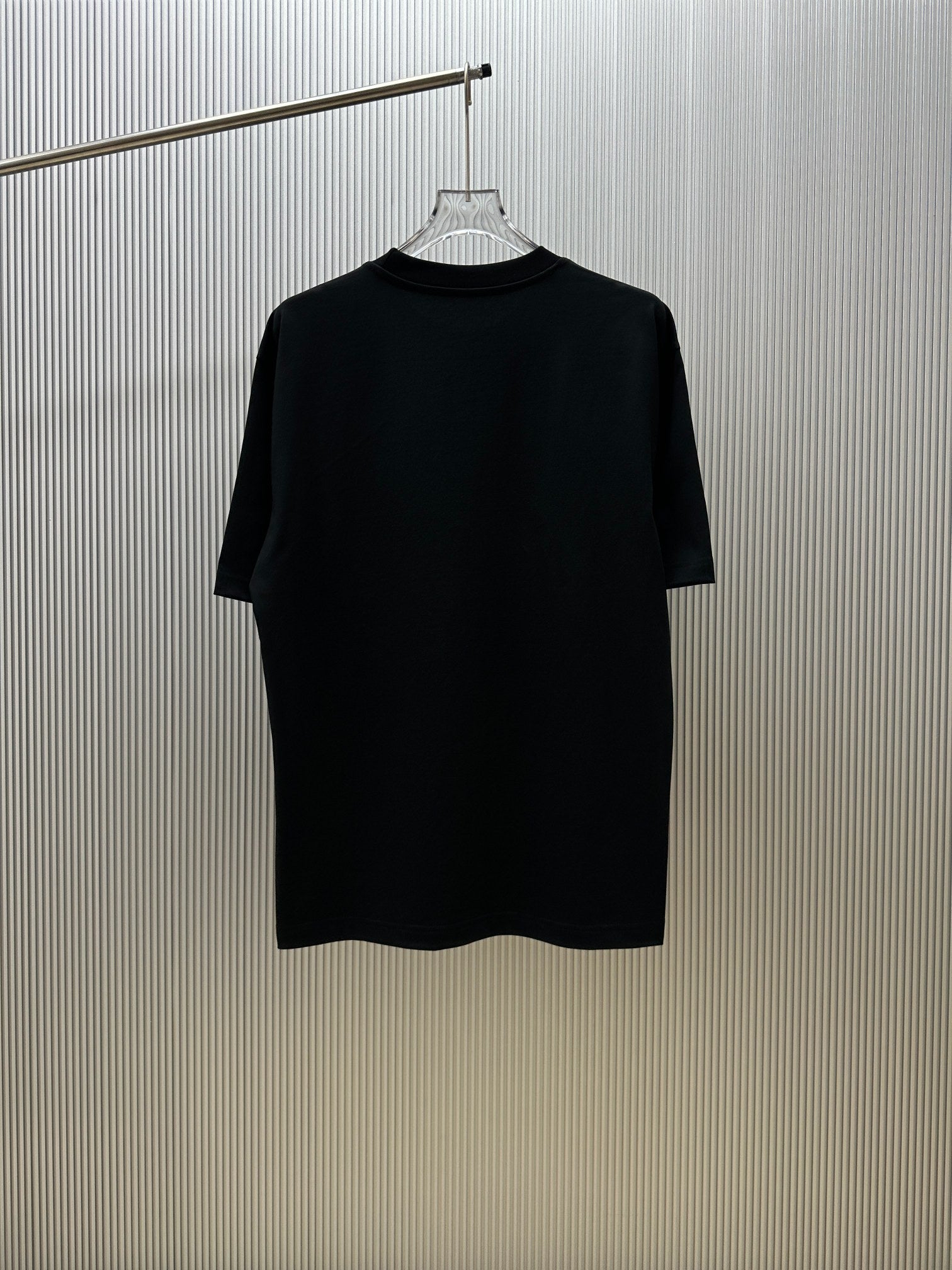 Black crew-neck short-sleeve T-shirt on a hanger