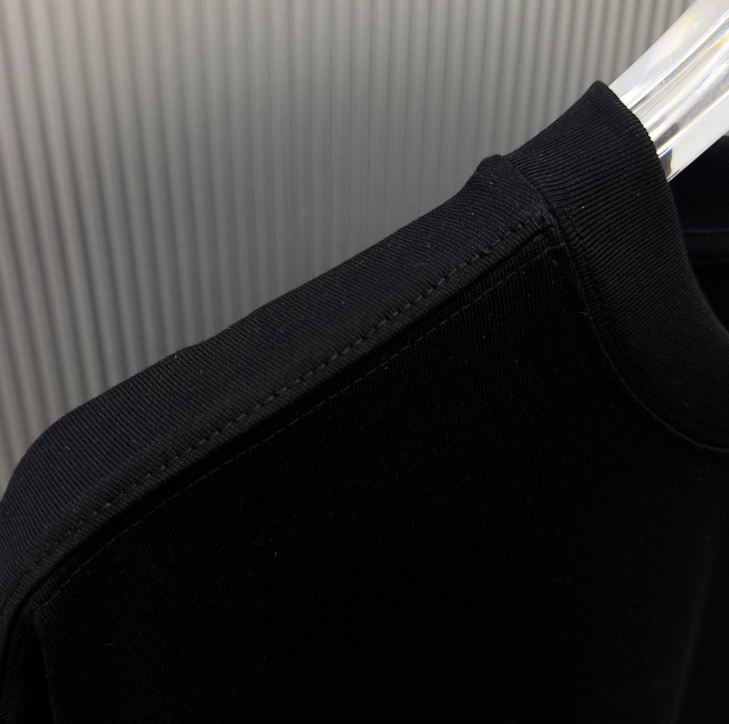 Black short-sleeve T-shirt sleeve cuff and shoulder seam close-up