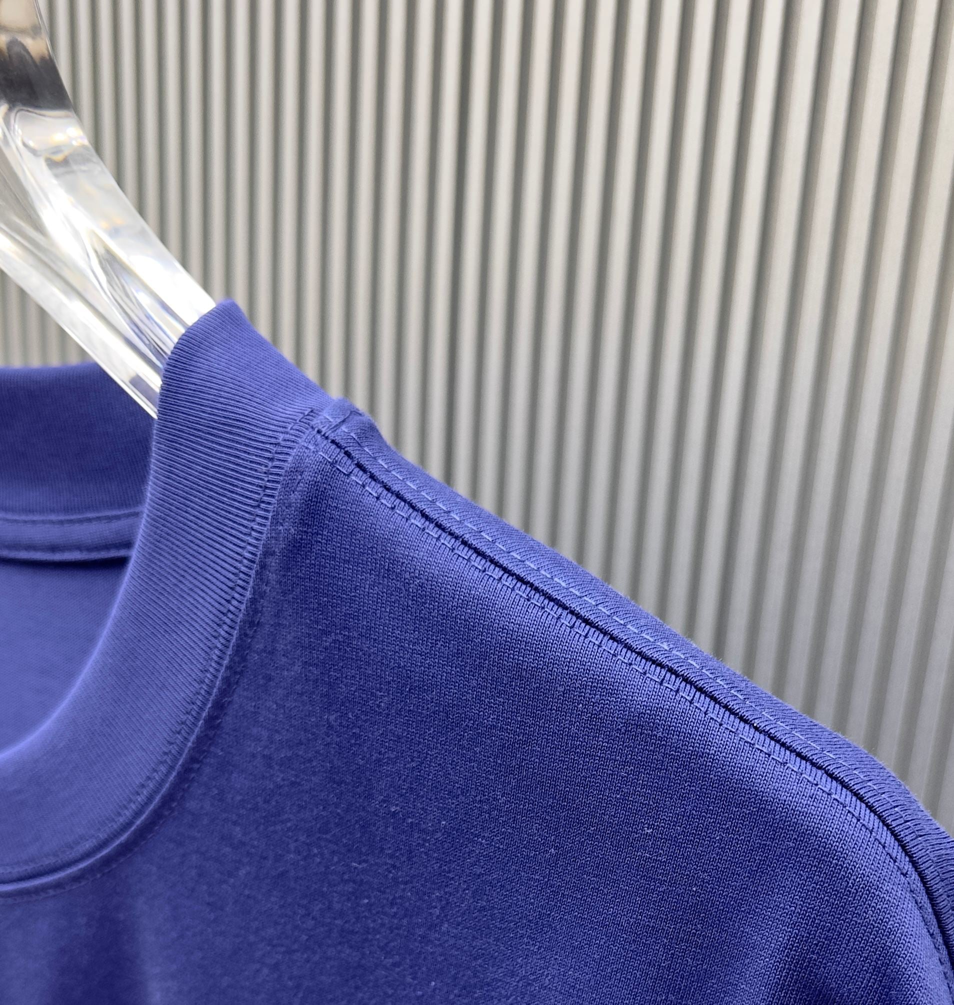 Blue Givenchy T-shirt sleeve and seam close-up