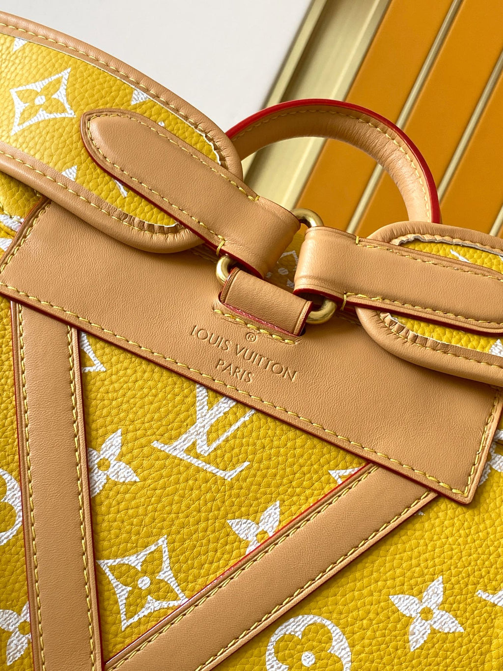Louis Vuitton yellow monogram satchel with brown strap, buckle, and stitched leather trim
