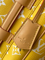 Louis Vuitton yellow monogram bag close-up of inner pocket and embossed logo patch