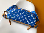 Louis Vuitton blue monogram bag with tan trim and straps, side close view