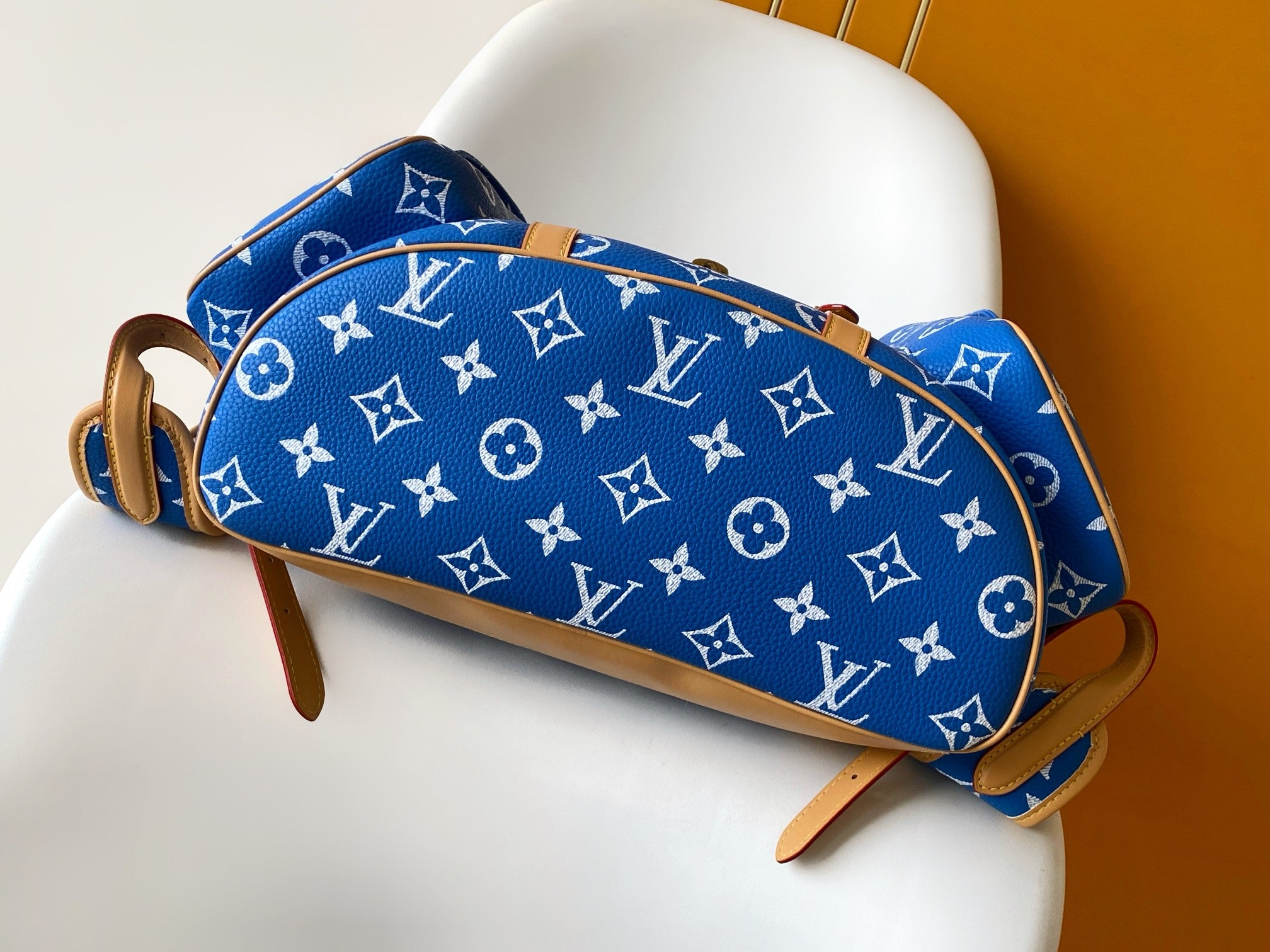 Louis Vuitton blue monogram bag with tan trim and straps, side close view