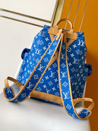 Louis Vuitton blue monogram bag with tan leather handles and adjustable crossbody strap