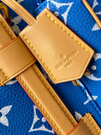 Louis Vuitton leather tab patch with logo and yellow stitching on blue monogram bag