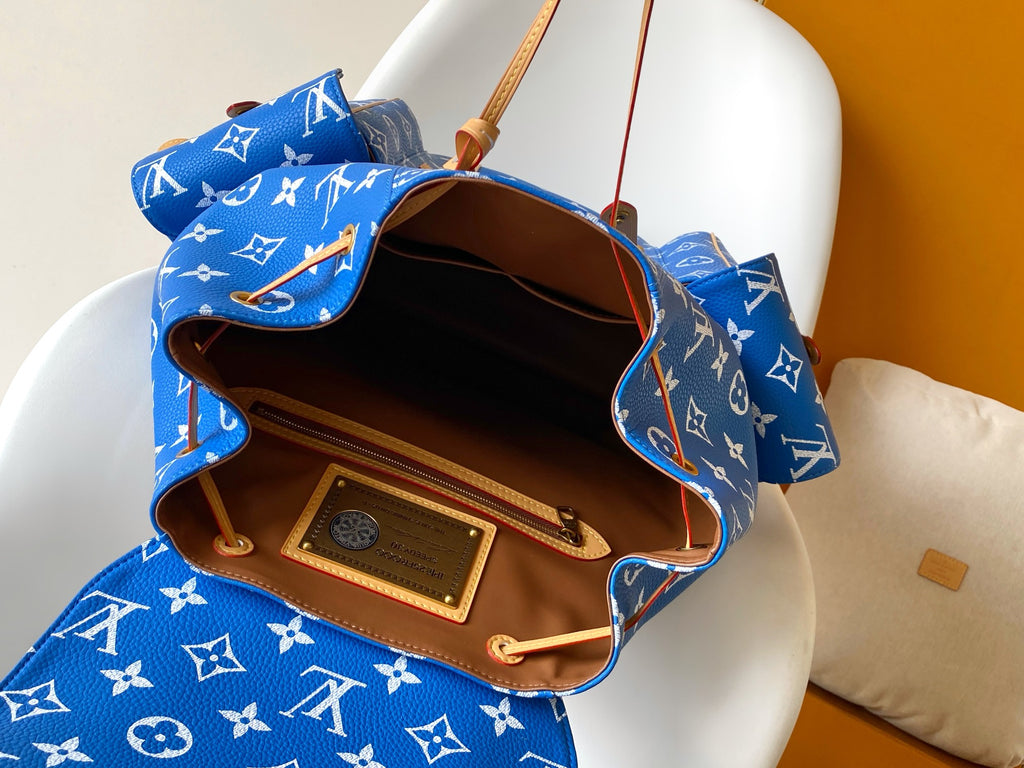 Louis Vuitton blue monogram bag with top open showing brown interior and pocket